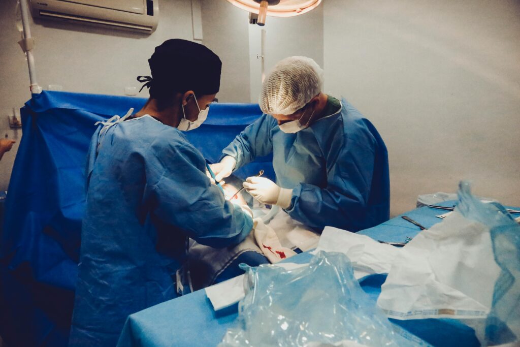 pexels-photo-3376799-3376799 Surgeons focusing on a procedure in an equipped operating room, showcasing teamwork and precision.